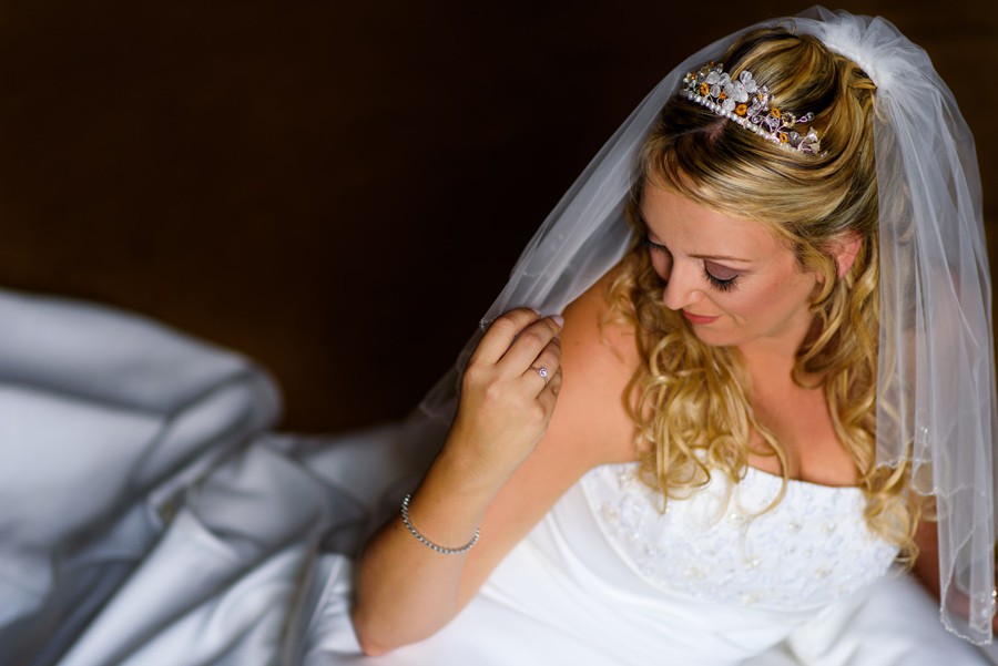 Colwick Hall wedding photograph of bride playing with veil before her wedding at 