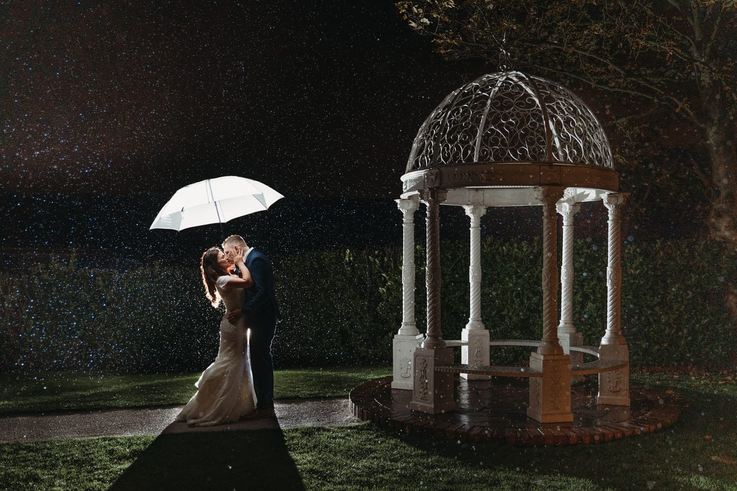 Raining photo of bride & groom outside Nottinghamshire Golf & Country Club