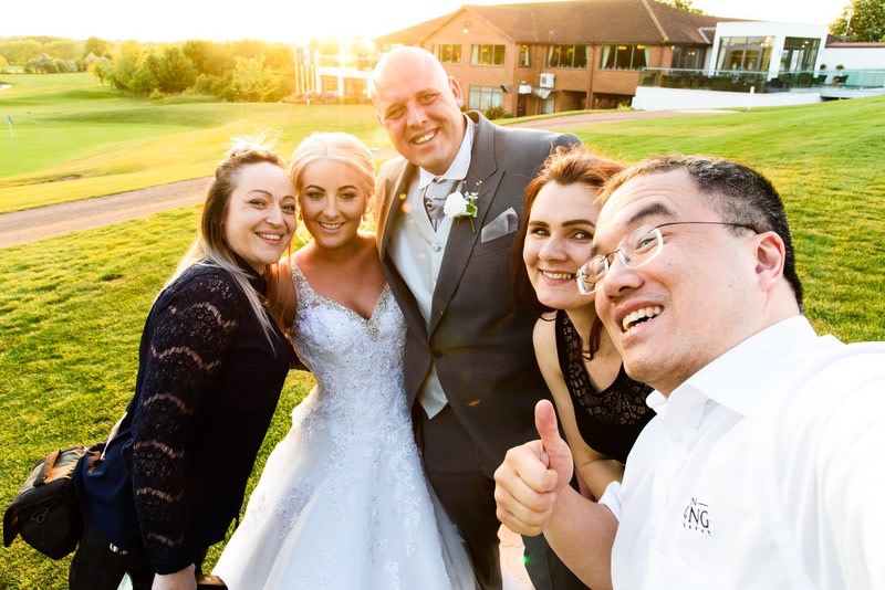 Taking a selfie with the bride & groom