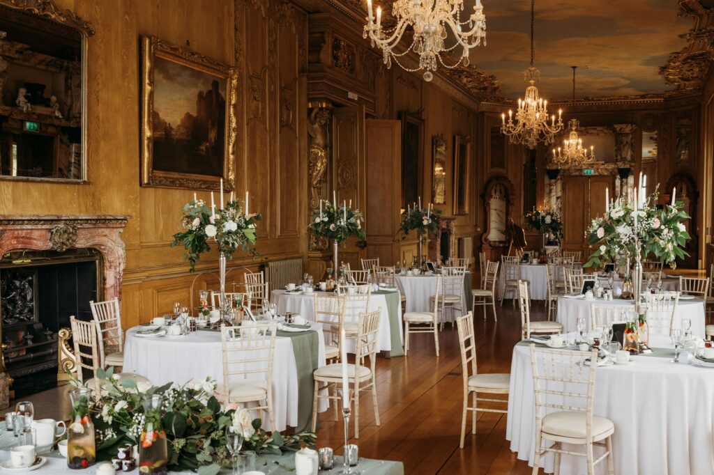 A photo from the back of the Long gallery with room decorated for a wedding breakfast at Harlaxton Manor