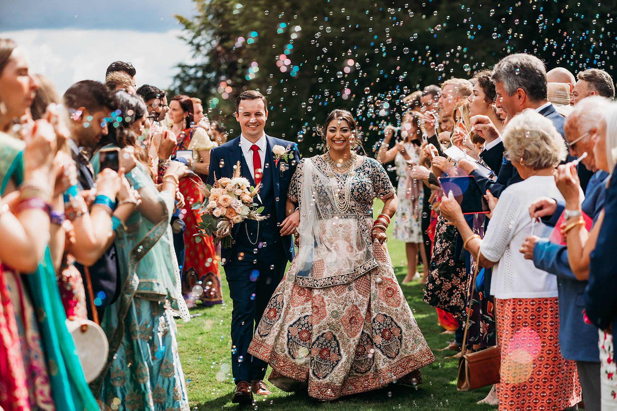 Bride & Groom walk through bubble tunnel at Ringwood Hall. A great alternative to confetti