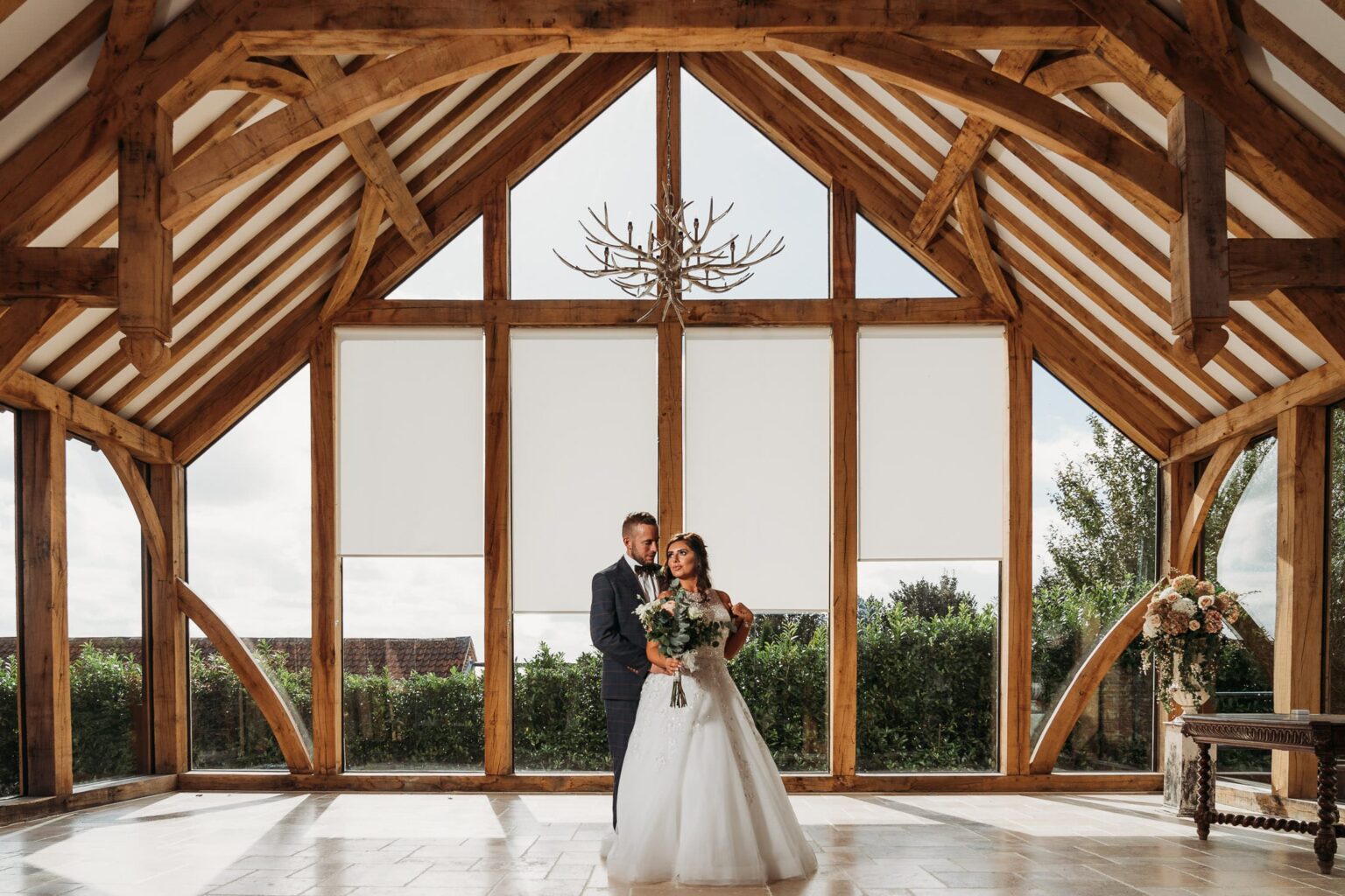 Wedding photo of bride & groom in the Glass Barn at Swancar Farm