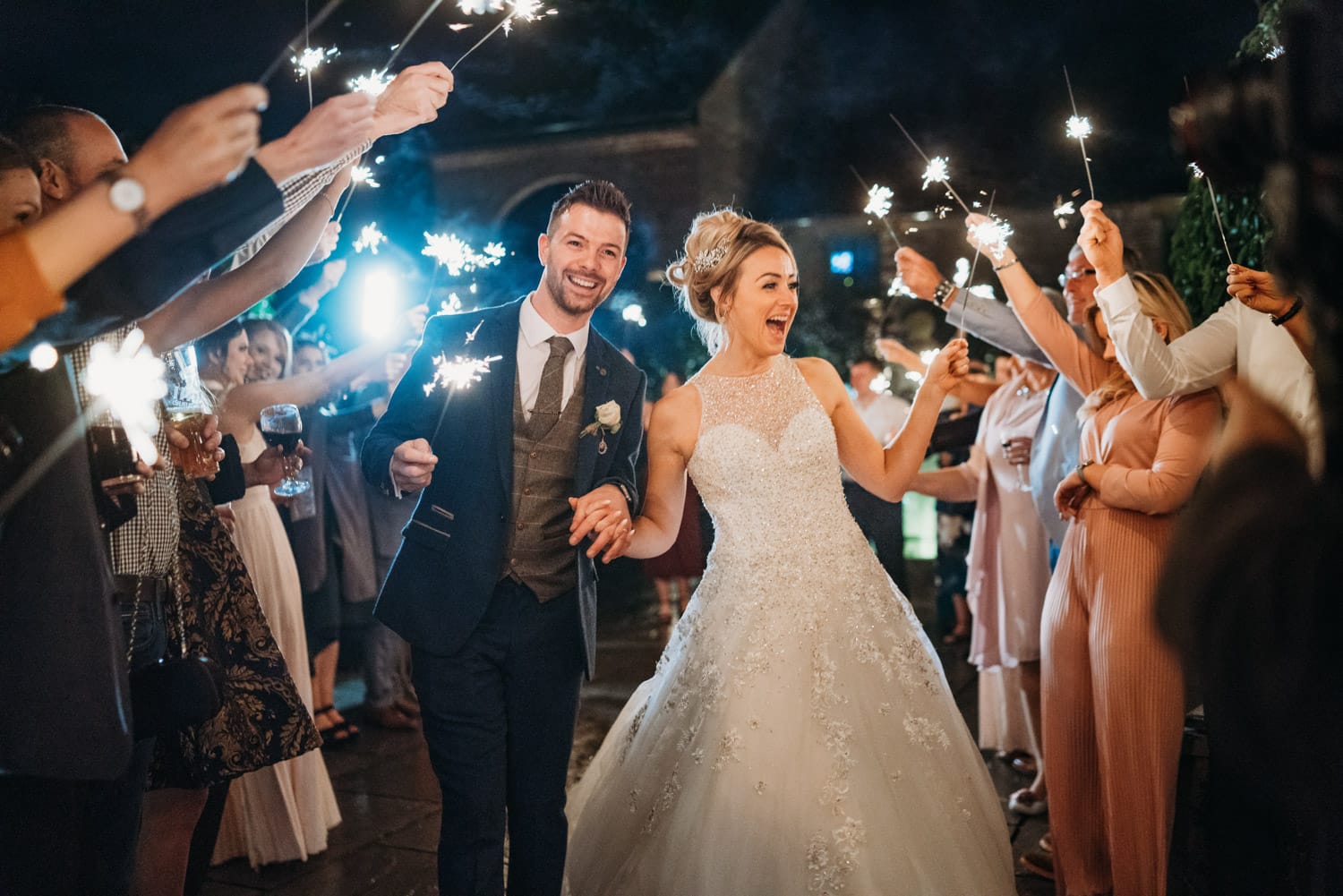 Bride & groom walking through sparkler tunnel at Hazel Gap Barn