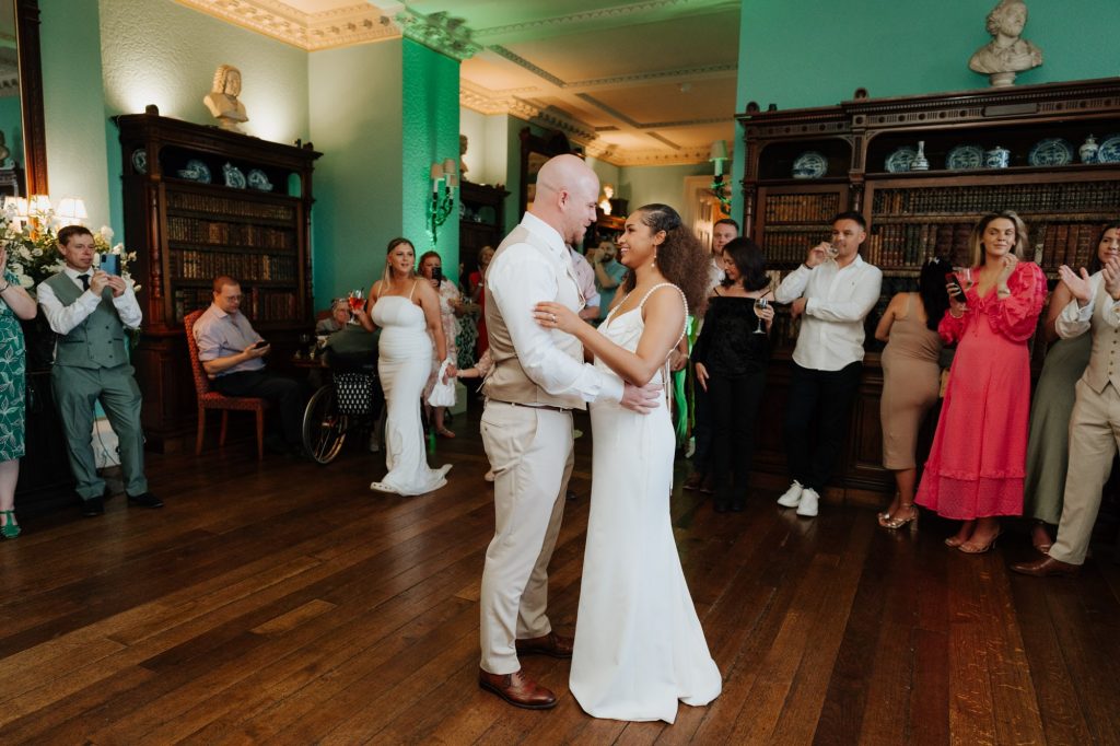 Newlyweds have a first dance at Preswold Hall in the library