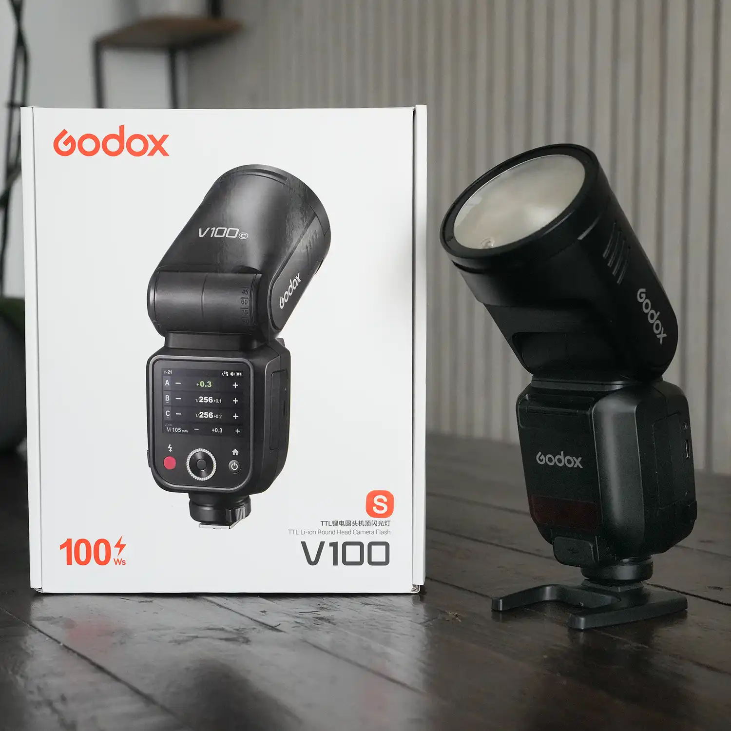 A godox V100 flash with it's original box