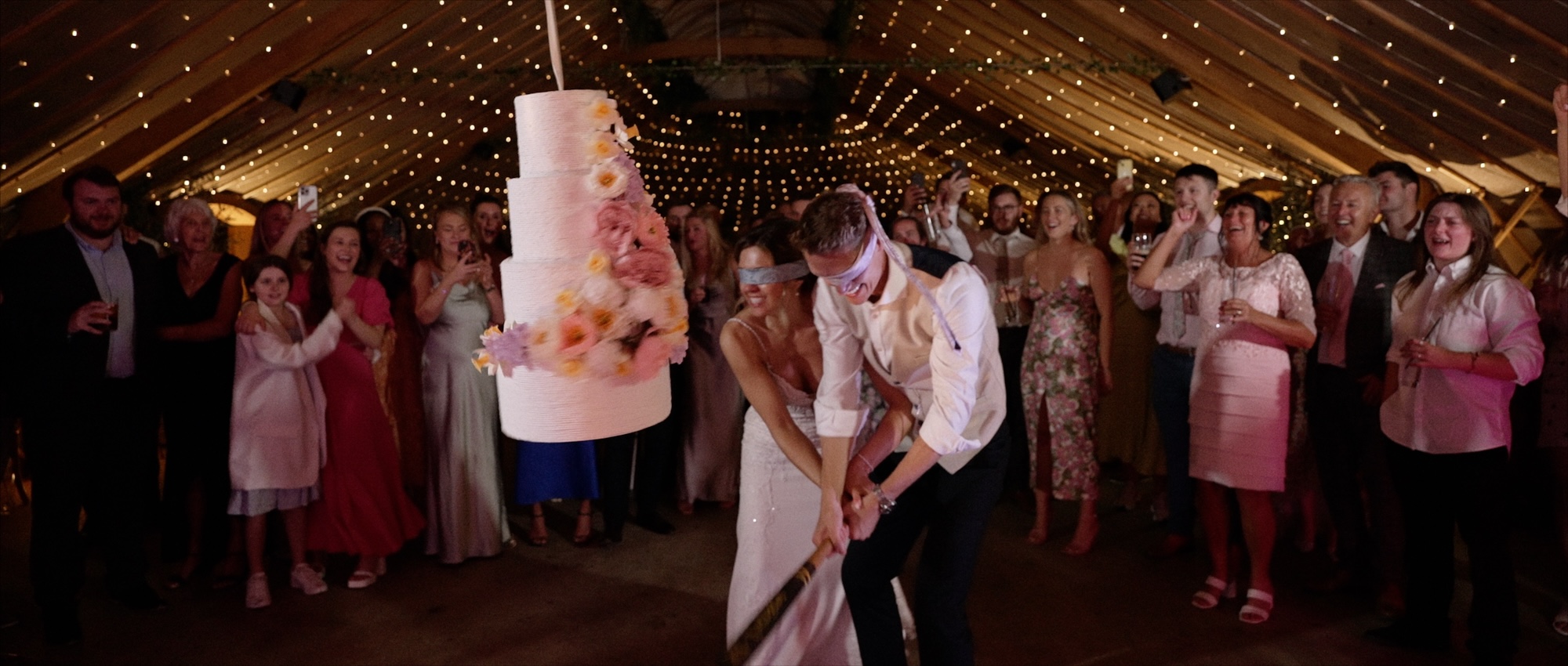 Bride & Groom smashing Pinata at Thorpe Garden wedding